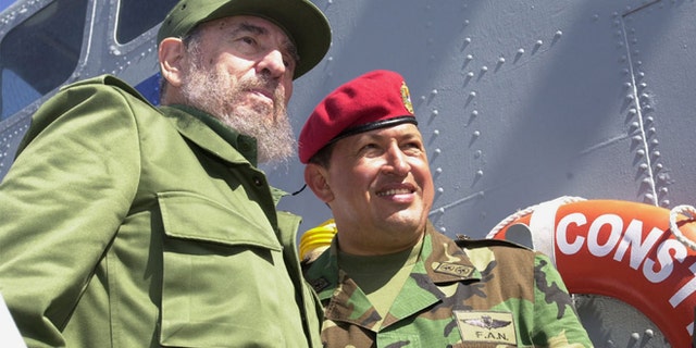 Cuban President Fidel Castro (L) and Venezuelan President Hugo Chavez travel onboard a Venezuelan Navy vessel from Porlamar to Pampatar prior a ceremony to promulgate a new Fishing Law, December 11, 2001 at Margarita Island, Venezuela. Castro is in Panpatar to attend the two-day meeting of the Association of Caribbean States (ACS). (Photo by Miraflores/Getty Images)