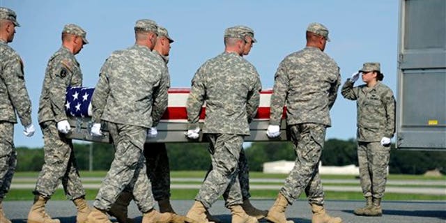 August 29: An Army carry team carries the transfer case containing the remains of Army Pfc. Jesse W. Dietrich, 20, of Venus, Texas, at Dover Air Force Base, DE.