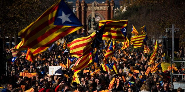 FILE - In this Nov. 22, 2015 file photo, pro Independence demonstrators wave "esteladas" or pro independence flags, during a demonstrations to show public support for the Parliament of Catalonia, in Barcelona, Spain. Spain's Constitutional Court has rejected a Catalan regional parliament resolution setting a road map for independence from Spain by 2017. In a sentence published Wed. Nov. 2, 2015, the court said the resolution adopted Nov. 9 by the Barcelona-based parliament violated five articles of the country's 1978 constitution and articles of the region's own statute. (AP Photo/Emilio Morenatti, File)