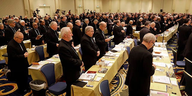 Members of the United States Conference of Catholic Bishops recite a group prayer during the USCCB's annual fall meeting in Baltimore, Tuesday, Nov. 15, 2016. Cardinal Daniel DiNardo of the Archdiocese of Galveston-Houston was elected Tuesday as president of the USCCB. (AP Photo/Patrick Semansky)