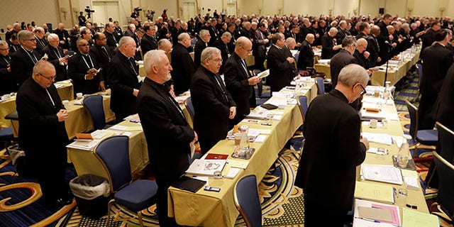Members of the United States Conference of Catholic Bishops recite a group prayer during the USCCB's annual fall meeting in Baltimore, Tuesday, Nov. 15, 2016. Cardinal Daniel DiNardo of the Archdiocese of Galveston-Houston was elected Tuesday as president of the USCCB. (AP Photo/Patrick Semansky)