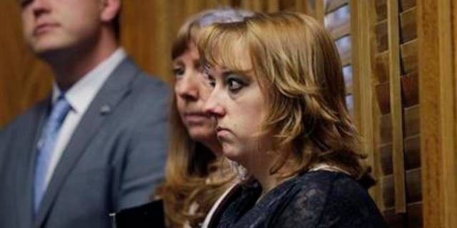 In this Monday, Jan. 28, 2013 photo, Heather Surovik, who lost her 8 1/2-month-old unborn son when her car was struck by drunken driver Gary Sheats in 2012, prepares to speak at a news conference promoting a political drive to grant personhood status to unborn fetuses at the Colorado State Capitol in Denver. Prosecutors could not file vehicular manslaughter charges because her unborn son was not legally a person. When a Catholic hospital in Colorado used the same argument to avoid a wrongful death lawsuit over twin fetuses that died in its care, it triggered an avalanche of criticism. At center is Surovik's mother, Terry Koester, and at left is Keith Mason of the organization Personhood USA. (AP Photo/Brennan Linsley)