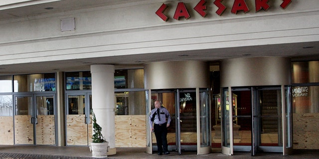 FILE: A security guard stands outside the entrance of Caesar's Casino on the Atlantic City boardwalk.