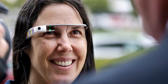 Cecilia Abadie wears her Google Glass as she talks with her attorney outside of traffic court in this Dec. 3, 2013 file photo taken in San Diego. The California woman believed to be the first cited for wearing Google's computer-in-an-eyeglass while driving says she was within her rights and violated no law. The case to be tried Thursday Jan. 16, 2014 in a San Diego traffic court could help shape future laws on wearable technology as it goes mainstream.