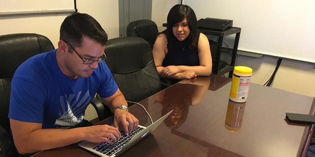 In this Wednesday, June 22, 2016 photo, Jesus Villarreal and Martha Guzman of the LULAC National Educational Service Centers, Inc., work on Hispanic student-related programs in the Albuquerque office, N.M. The nation's Hispanic population grew by 2.2 percent to 56.6 million, and New Mexico had the largest percentage of Latinos in the country at 48 percent, according to new information from the U.S. Census Bureau. (AP Photo/Russell Contreras)