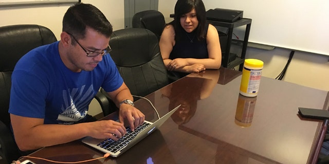 In this Wednesday, June 22, 2016 photo, Jesus Villarreal and Martha Guzman of the LULAC National Educational Service Centers, Inc., work on Hispanic student-related programs in the Albuquerque office, N.M. The nation's Hispanic population grew by 2.2 percent to 56.6 million, and New Mexico had the largest percentage of Latinos in the country at 48 percent, according to new information from the U.S. Census Bureau. (AP Photo/Russell Contreras)