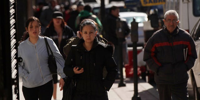 UNION CITY, NJ - MARCH 28: Hispanic residents walk down a street on March 28, 2011 in Union City, New Jersey. Union City New Jersey, one of the stateâs largest cities, has a population of Hispanic or Latino origin of over 80%. According to the new 2010 Census Bureau statistics reported last Thursday, the Hispanic population in the United States has grown by 43% in the last decade, surpassing 50 million and accounting for about 1 out of 6 Americans. (Photo by Spencer Platt/Getty Images)