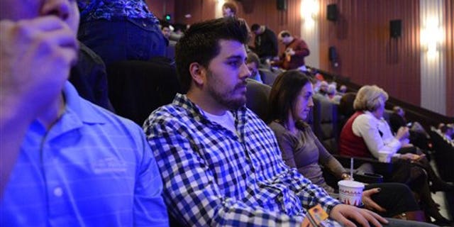 Guests wait in their seats for the reopening and remembrance ceremony at the Century Aurora cinema, formerly the Century 16, Thursday, Jan. 17, 2013 in Aurora, Colo.