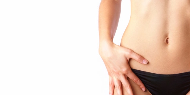 Belly of beautiful woman isolated on white copyspace