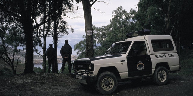 Civil guards watch over the frontier of Ceuta Two civil guards next to their automobile watch over the frontier of Ceuta. (Photo by JMN/Cover/Getty Images)