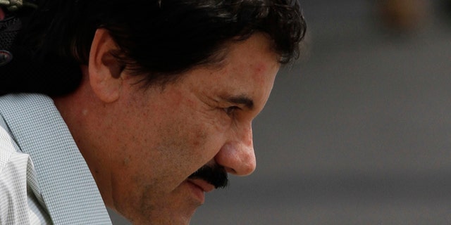 Joaquin "El Chapo" Guzman is escorted to a helicopter in handcuffs by Mexican navy marines at a navy hanger in Mexico City, Saturday, Feb. 22, 2014. A senior U.S. law enforcement official said Saturday, that Guzman, the head of Mexico's Sinaloa Cartel, was captured alive overnight in the beach resort town of Mazatlan. Guzman faces multiple federal drug trafficking indictments in the U.S. and is on the Drug Enforcement Administration's most-wanted list. (AP Photo/Marco Ugarte)