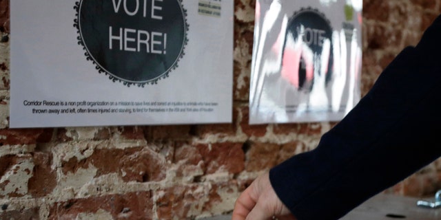 Jan. 16, 2013: A patron drops a ticket into a voting box at the Original OKRA Charity Saloon in Houston.