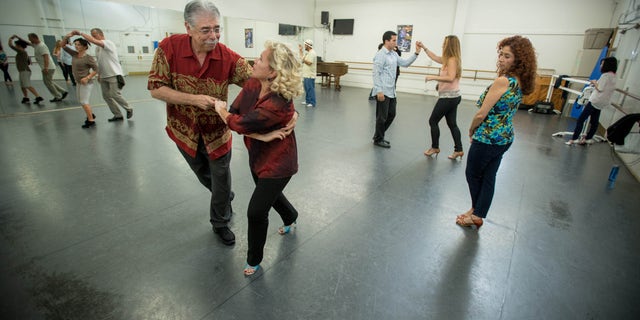 Charles Trevino, a patient at Cedars-Sinai Medical Center, and his wife Carmen during salsa dancing lessons at the Pasadena Dance Theatre, Thursday, Nov. 14, 2013. (Eric Reed/Cedars-Sinai Medical Center)