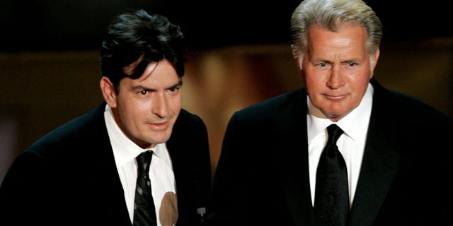 LOS ANGELES, CA - AUGUST 27: Actors Charlie Sheen (L) and Martin Sheen present the award for Outstanding Supporting Actress in a Drama Series onstage at the 58th Annual Primetime Emmy Awards at the Shrine Auditorium on August 27, 2006 in Los Angeles, California. (Photo by Vince Bucci/Getty Images)
