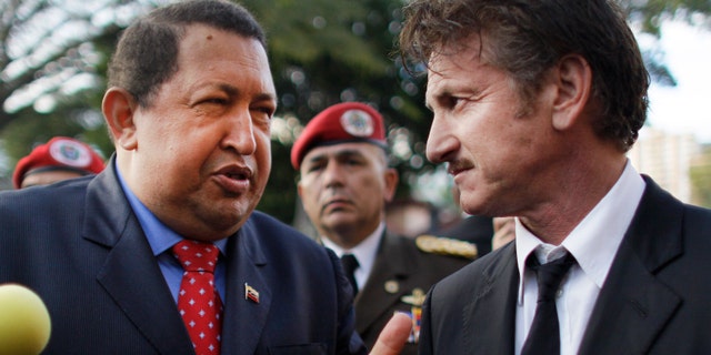 Venezuela's President Hugo Chavez, left, talks to actor Sean Penn, of United States, who visited the presidential palace in Caracas, Venezuela, Thursday, Feb. 16, 2012. (AP Photo/Ariana Cubillos)