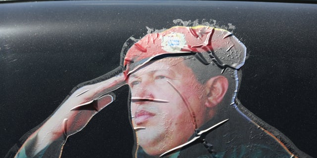 CARACAS, VENEZUELA - MARCH 04: A sticker on a car window honors former Venezuelan president Hugo Chavez near the military barracks where Chavez is entombed on March 4, 2014 in Caracas, Venezuela. (Photo by John Moore/Getty Images)