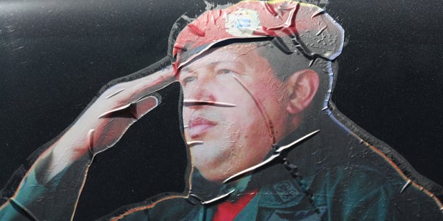 CARACAS, VENEZUELA - MARCH 04: A sticker on a car window honors former Venezuelan president Hugo Chavez near the military barracks where Chavez is entombed on March 4, 2014 in Caracas, Venezuela. (Photo by John Moore/Getty Images)