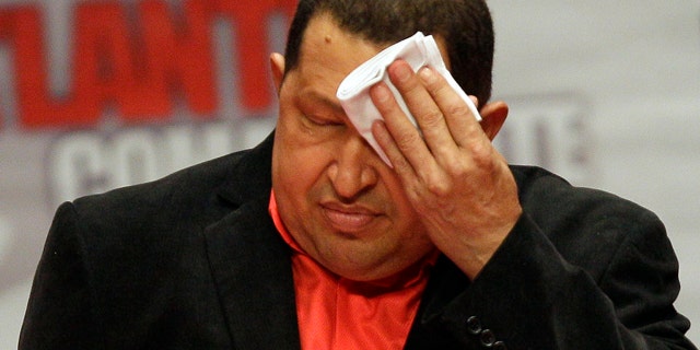 Feb. 23: President Hugo Chavez wipes his forehead as he attends a concert in his honor at the Teresa Carreno Theater in Caracas, Venezuela.