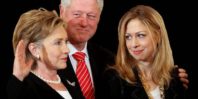 Former President Bill Clinton, center, and daughter Chelsea Clinton, right, look on during a ceremonial swearing-in for Secretary of State Hillary Rodham Clinton, Monday, Feb. 2, 2009, at the State Department in Washington. (AP Photo/Haraz N. Ghanbari)