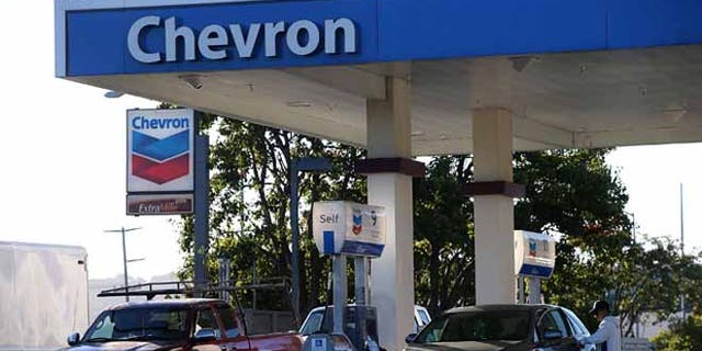CORTE MADERA, CA - OCTOBER 30: Customers get gasoline at a Chevron station on October 30, 2015 in Corte Madera, California. Chevron announced plans to cut up to 7,000 jobs as oil prices continue to slump. Chevron's third quarter revenue fell 37.2% to $34.3 billion compared to one year ago. (Photo by Justin Sullivan/Getty Images)