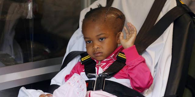 Four-year-old Jacele Johnson, who was shot in the head on May 22 outside a prom party in Chicago's Englewood neighborhood, waves to the media as she is released from Comer Childrens Hospital on Monday, June 1, 2015, in Chicago. Johnson was put in an ambulance that would take her to a Minnesota hospital where she will undergo further treatment. (Jose M. Osorio/Chicago Tribune via AP) MANDATORY CREDIT CHICAGO TRIBUNE; CHICAGO SUN-TIMES OUT; DAILY HERALD OUT; NORTHWEST HERALD OUT; THE HERALD-NEWS OUT; DAILY CHRONICLE OUT; THE TIMES OF NORTHWEST INDIANA OUT; TV OUT; MAGS OUT; NO SALES