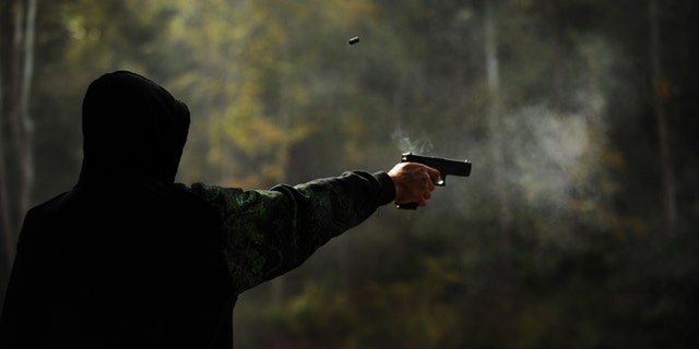 WEST POINT, KY - OCTOBER 10: Alex Soballe, 17, of Chicago, Ill. shoots a 9mm handgun at the Knob Creek Machine Gun Shoot on October 10, 2009 in West Point, Kentucky. The Supreme Court is currently hearing a portion of last year's Second Amendment case, District of Columbia v. Heller, that found that the amendment protects a person's right that the federal government can not abridge. (Photo by Matt McClain/Getty Images)