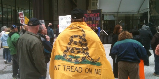 A tea party activist wears a replica of the 1775 Gadsden flag at the 2012 Tea Party Tax Day Rally in Chicago, Ill. (Michael Volpe / The Daily Caller)