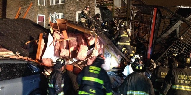 November 23, 2014: Chicago firefighters sift through the rubble of an apartment building that collapsed after a possible gas explosion on the city's South Side Sunday evening. (MyFoxChicago.com)