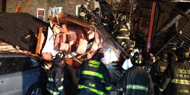 November 23, 2014: Chicago firefighters sift through the rubble of an apartment building that collapsed after a possible gas explosion on the city's South Side Sunday evening. (MyFoxChicago.com)