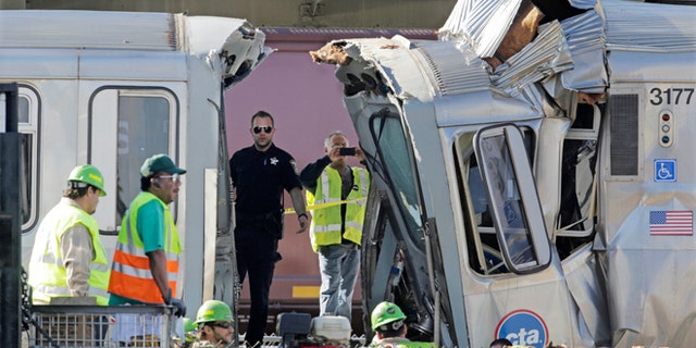 Sept. 30, 2013: Authorities inspect the wreckage of two Chicago Transit Authority trains that crashed in Forest Park, Ill.