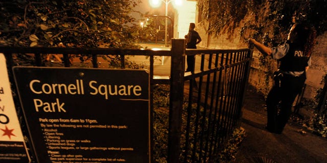 Sept. 20, 2013: In this file photo, Chicago Police detectives investigate the scene where 13 people, including a 3-year-old child, were shot in a city park in Chicago.