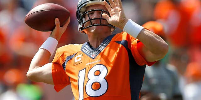 Denver Broncos quarterback Peyton Manning warms up prior to an NFL football game against the Kansas City Chiefs, Sunday, Sept. 14, 2014, in Denver. (AP Photo/Jack Dempsey)