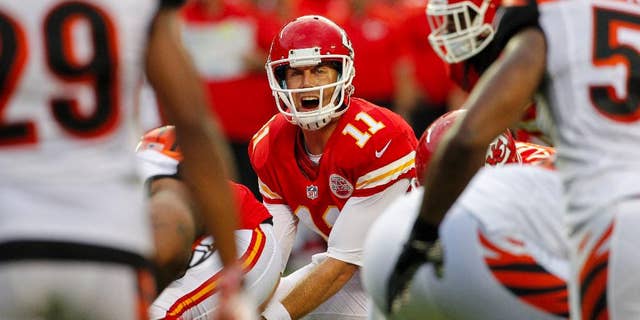 FILE - In this Aug. 7, 2014, file photo, Kansas City Chiefs quarterback Alex Smith (11) calls a play in the first half of an NFL preseason football game against the Cincinnati Bengals in Kansas City, Mo. Smith signed a $68 million extension Sunday, Aug. 31, 2014, to remain with the Chiefs through the 2018 season, a person familiar with the deal told The Associated Press. The person spoke on condition of anonymity because the team did not disclose the terms of the contract. (AP Photo/Colin E. Braley, File)