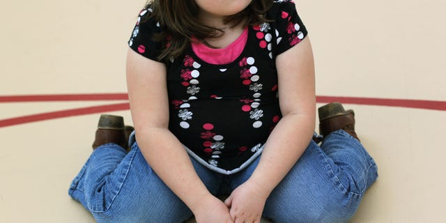 AURORA, CO - NOVEMBER 13: A child sits on the gym floor during the Shapedown program for overweight adolescents and children on November 13, 2010 in Aurora, Colorado. The 10-week family-centered program held by the Denver area Children's Hospital teaches youth and their parents ways to lead a healthier more active lifestyle, as a longer lasting weight-loss alternative to dieting. Nationally, some 15 percent of children are overweight or obese, as are some 60 percent of adults. (Photo by John Moore/Getty Images)