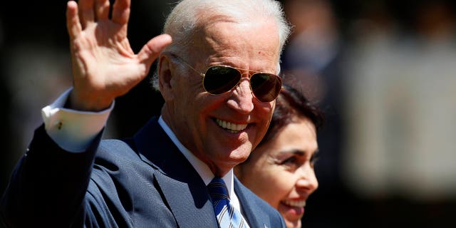 Vice President Joe Biden waves as he walks through the Cerro Castillo palace gardens on his way to having lunch with Chile's newly sworn-in President Michelle Bachelet, in Vina del Mar, Chile, Tuesday, March 11, 2014. (AP Photo/Luis Hidalgo)