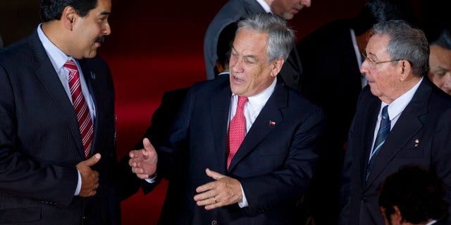Jan. 27, 2013 - Chile's President Sebastian Pinera, center, speaks with Cuba's President Raul Castro, right, and Venezuela's Vice President Nicolas Maduro, left, at CELAC (Community of Latin American and Caribbean Countries) summit in Santiago, Chile.