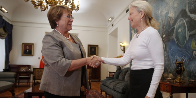 Kristine McDivitt Tompkins, widow of late American conservationist Doug Tompkins, left, shakes hands with Chile's President Michelle Bachelet at La Moneda Palace in Santiago, Chile, Thursday, Jan. 21, 2016. McDivitt Tompkins said that since her husband died last month while kayaking in South Americas Patagonia region at age 72, she has been working non-stop to permanently protect from future development the millions of acres they acquired over a quarter-century. (AP Photo/Luis Hidalgo)