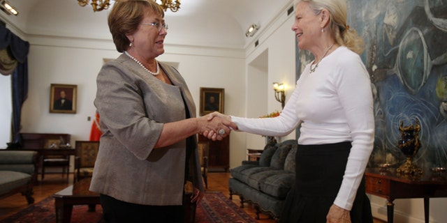 Kristine McDivitt Tompkins, widow of late American conservationist Doug Tompkins, left, shakes hands with Chile's President Michelle Bachelet at La Moneda Palace in Santiago, Chile, Thursday, Jan. 21, 2016. McDivitt Tompkins said that since her husband died last month while kayaking in South Americas Patagonia region at age 72, she has been working non-stop to permanently protect from future development the millions of acres they acquired over a quarter-century. (AP Photo/Luis Hidalgo)