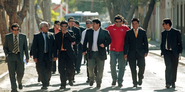 Former trapped miners, from left, Victor Zamora, Omar Reigadas, Claudio Yanez, Pedro Cortez, Carlos Bugueno, Esteban Rojas, Samuel Avalos, Carlos Mamani and Jimmy Sanchez arrive to attend a Mass marking the first anniversary of the San Jose mine collapse in Copiapo, Chile, Friday Aug. 5, 2011. The 33 miners survived 69 days, 700 feet deep after an unprecedented and dramatic Oct. 13, 2010 rescue.