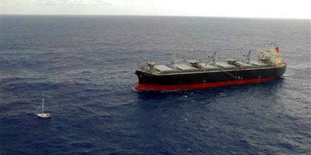 Jan. 4: Japan's merchant ship White Kingdom, right, approaches the 32-foot sailboat of U.S. sailor Thomas Louis Corogin to rescue him in the Pacific Ocean south of Easter Island, Chile.
