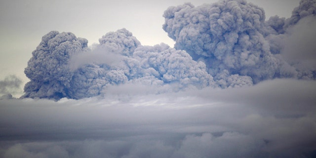 A cloud of volcanic ashes and smoke from the Puyehue-Cordon Caulle volcano is seen from Entrelagos, in southern Chile, Friday, June 10, 2011. The volcano erupted Saturday after remaining dormant for decades, causing the evacuation of about 3,500 people in the nearby area and carrying ash across the Andes to Argentina. (AP Photo/Roberto Candia)