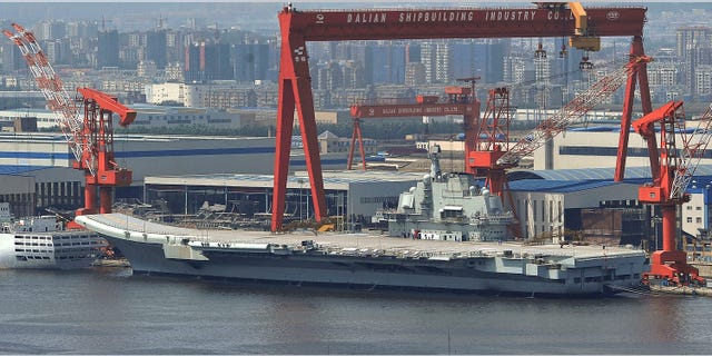 Aug. 6: In this photo, a Chinese aircraft carrier, which had been under refurbishment, is docked at Dalian port in in northeast Liaoning province. China's first aircraft carrier started sea trials Wednesday, Aug. 10, a step that will likely boost concerns about the country's naval ambitions amid sea territorial disputes.