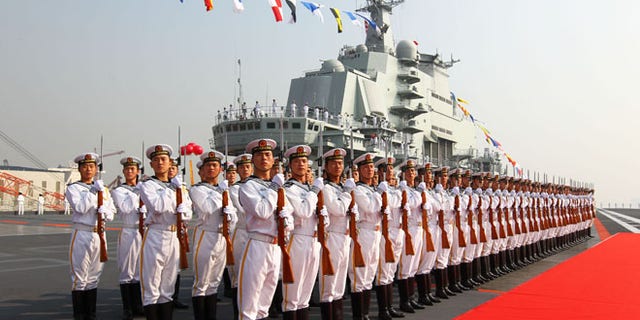 Sept. 25, 2012: Military officers stand onboard China's aircraft carrier "Liaoning" in Dalian, northeast China's Liaoning Province, as the country formally entered its first aircraft carrier into service.