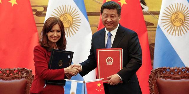 Chinese President Xi Jinping, right, and then Argentinian President Cristina Fernandez shake hands after signing documents following their meeting at the Great Hall of the People in Beijing in 2015.