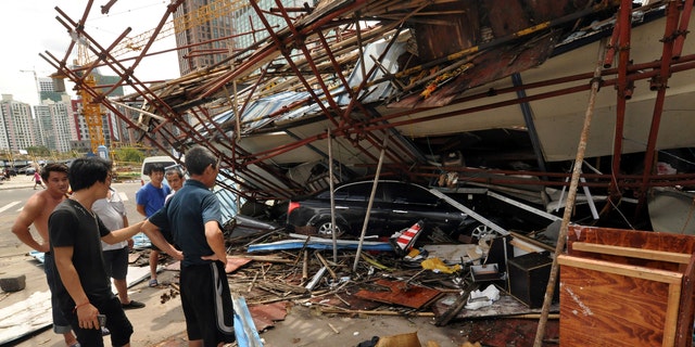 July 19, 2014 - Vehicle sits under a collapsed building after landfall of typhoon Rammasun in Haikou, capital of south China's Hainan Province. The strongest typhoon to hit southern China in four decades has killed at least 26 people in China, and 11 more in Vietnam.