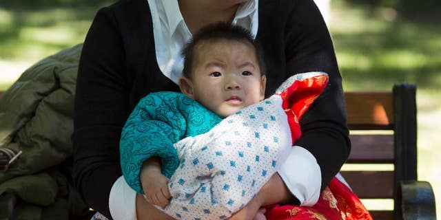 A senior Chinese health official says the country can expect its population to start shrinking before 2025. (AP Photo/Ng Han Guan)