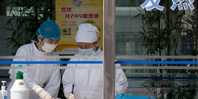 April 14, 2013: Nurses collect patients' blood samples at a specialized fever clinic inside the Ditan Hospital, where a Chinese girl is being treated for the H7N9 strain of bird flu, in Beijing.