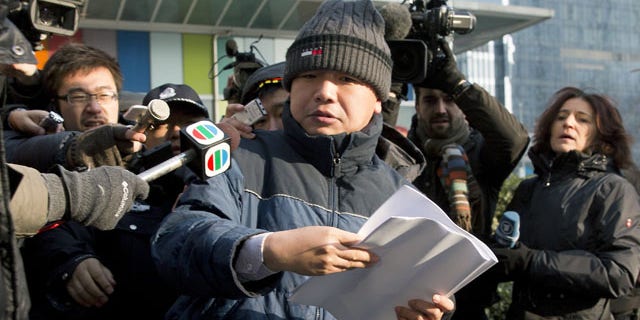 January 26, 2014: Zhang Qingfang, lawyer of legal scholar and founder of the New Citizens movement Xu Zhiyong, speaks to the media near the No. 1 Intermediate People's Court, in Beijing . The Beijing court on Sunday sentenced Xu to four years in jail for disrupting order in public places, in a case that the U.S. government and other critics say is retribution against his push to fight corruption and create equal educational opportunities. (AP Photo/Andy Wong)