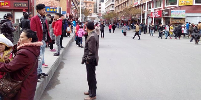 Nov. 22, 2014: In this photo released by China's Xinhua News Agency, locals stand outside after a quake hit Kangding County in Sichuan Province, China. (AP)