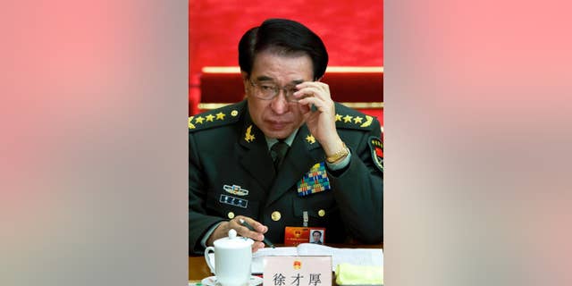 FILE - In this March 11, 2012 file photo, Xu Caihou, then deputy chairman of the Communist Party of China (CPC) Central Military Commission, which controls China's military, attends a plenary session of the National People's Congress at the Great Hall of the People in Beijing, China. Former No. 2 military official Xu, who was under investigation for alleged massive bribe-taking, has died in a hospital of cancer, the state Xinhua News Agency reported early Monday, March 16, 2015. He was 71.(AP Photo/Andy Wong, File)
